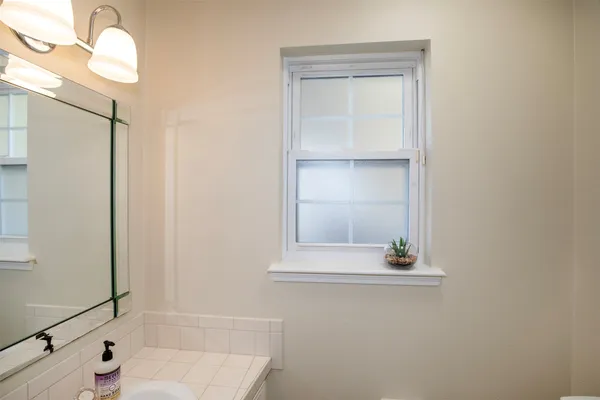 a view of a house with backyard and a tree