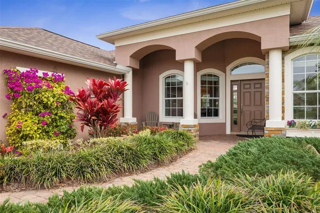 a living room with furniture a chandelier and a window