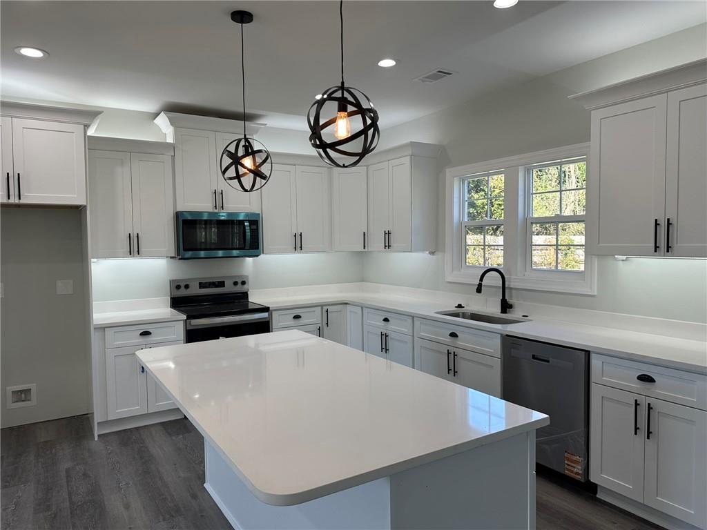 2513 Weldon Drive Augusta, GA 30906 - Photo 17 of 33 a kitchen with stainless steel appliances a stove a sink a window and white cabinets
