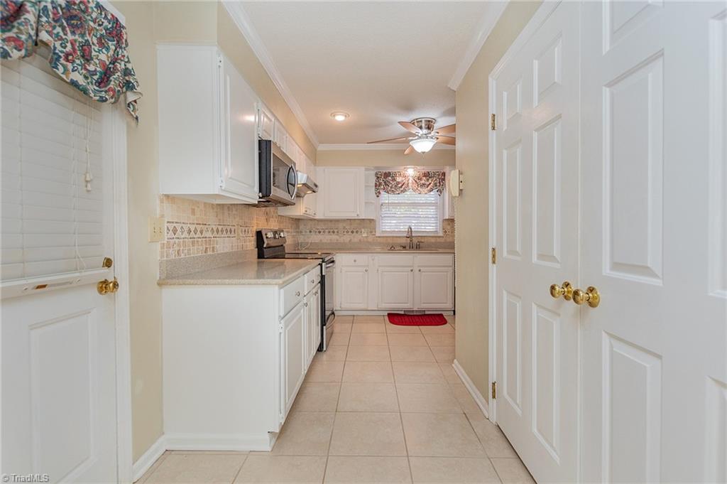 5414 Tower Road Greensboro, NC 27410 - Photo 12 of 45 Kitchen entry from garage (laundry doors on right)