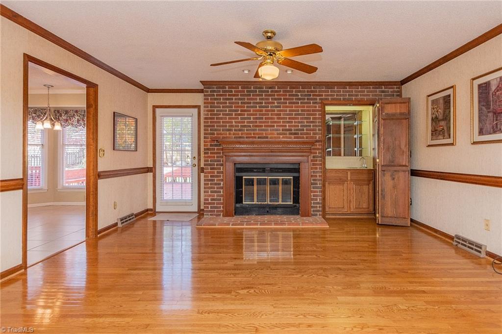5414 Tower Road Greensboro, NC 27410 - Photo 9 of 45 Den also has a lovely fireplace. Door leads to back deck and yard
