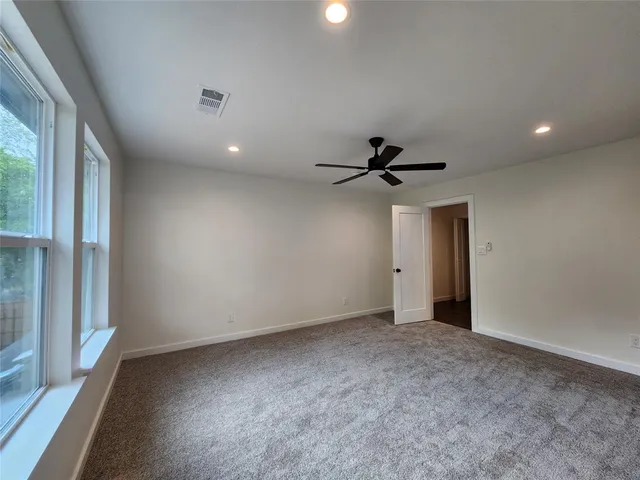 a view of a livingroom with a ceiling fan and window