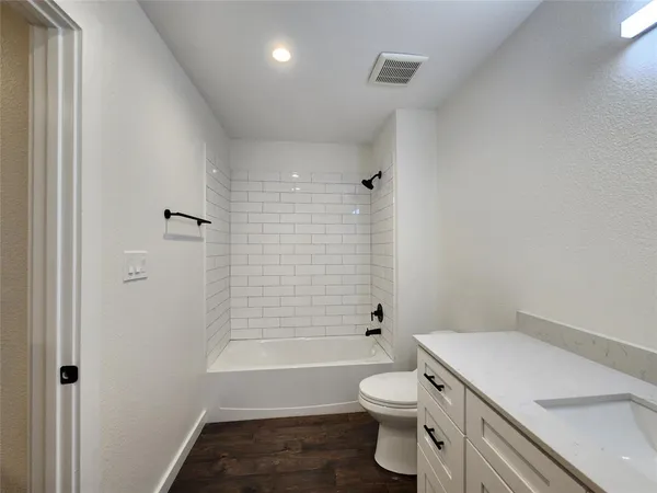 a bathroom with a toilet a sink and bathtub