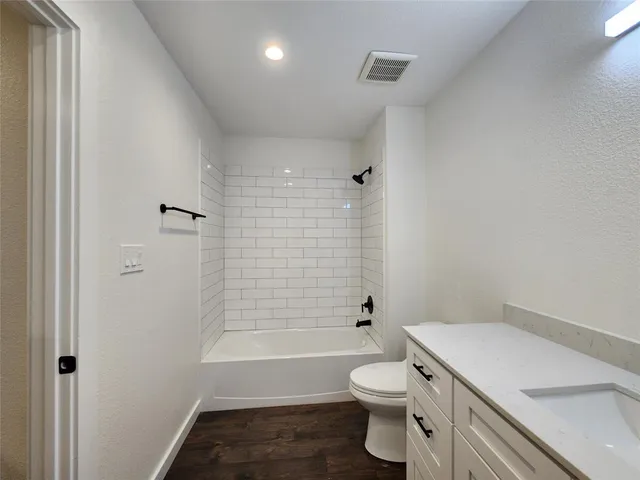 a bathroom with a toilet a sink and bathtub