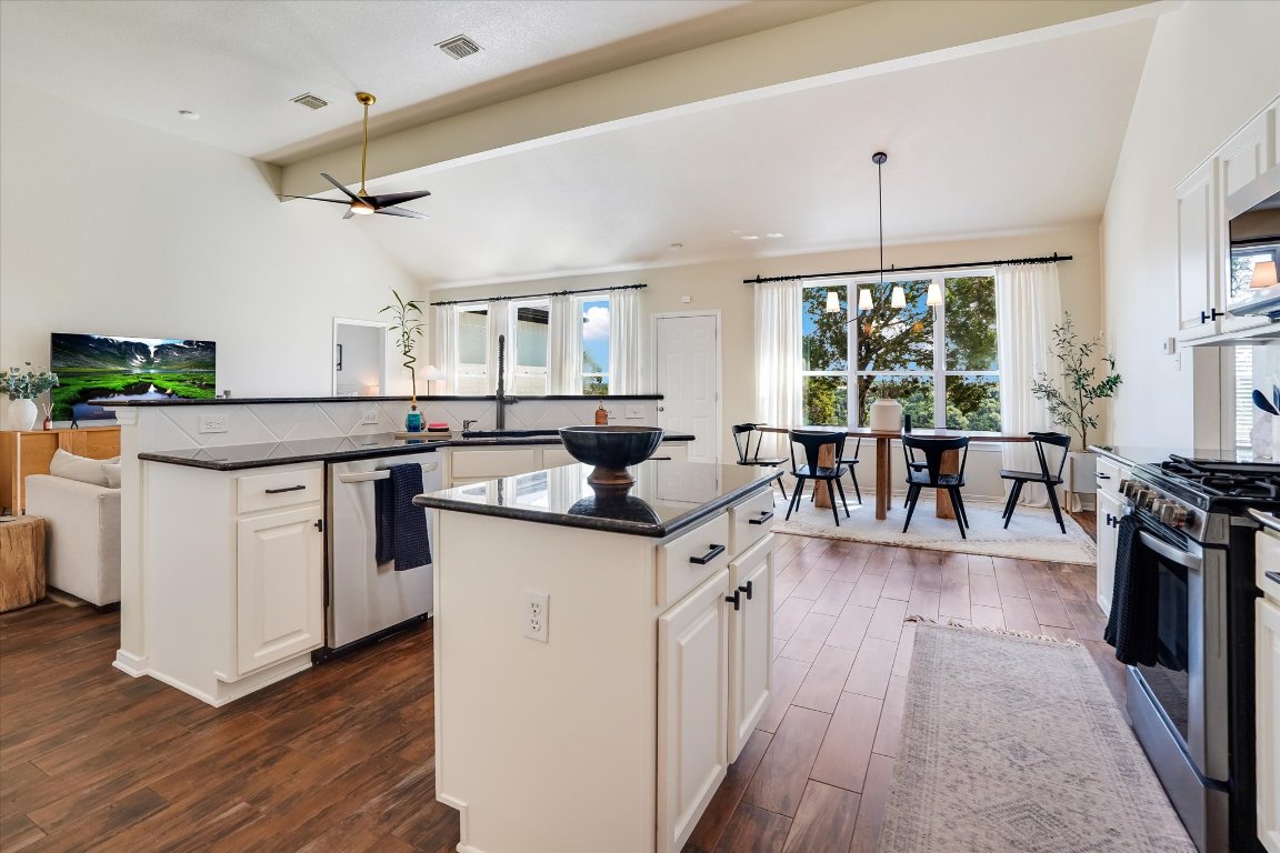 13201 North Ridge Circle Leander, TX 78641 - Photo 11 of 33 a kitchen with stainless steel appliances a stove top oven and a dining table