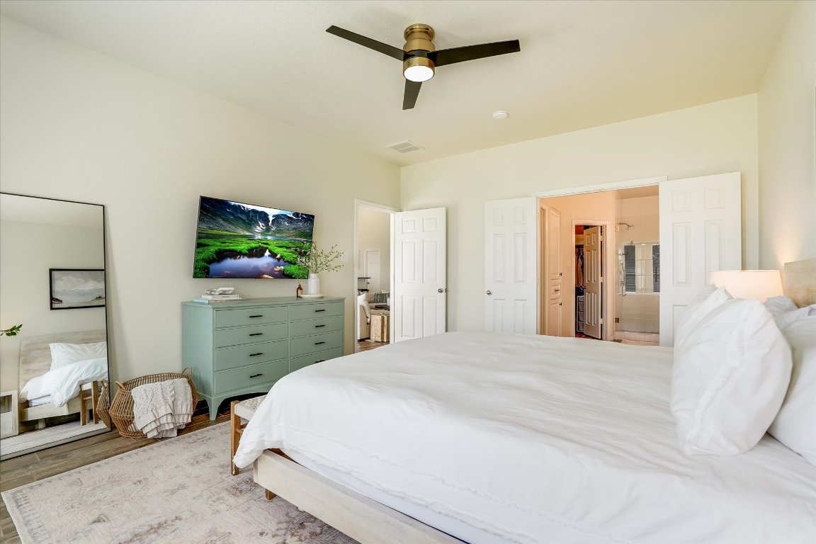 13201 North Ridge Circle Leander, TX 78641 - Photo 17 of 33 a bedroom with a bed and a flat screen tv