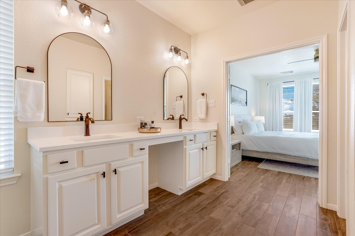 13201 North Ridge Circle Leander, TX 78641 - Photo 19 of 33 a spacious bathroom with a double vanity sink a mirror and a bathtub
