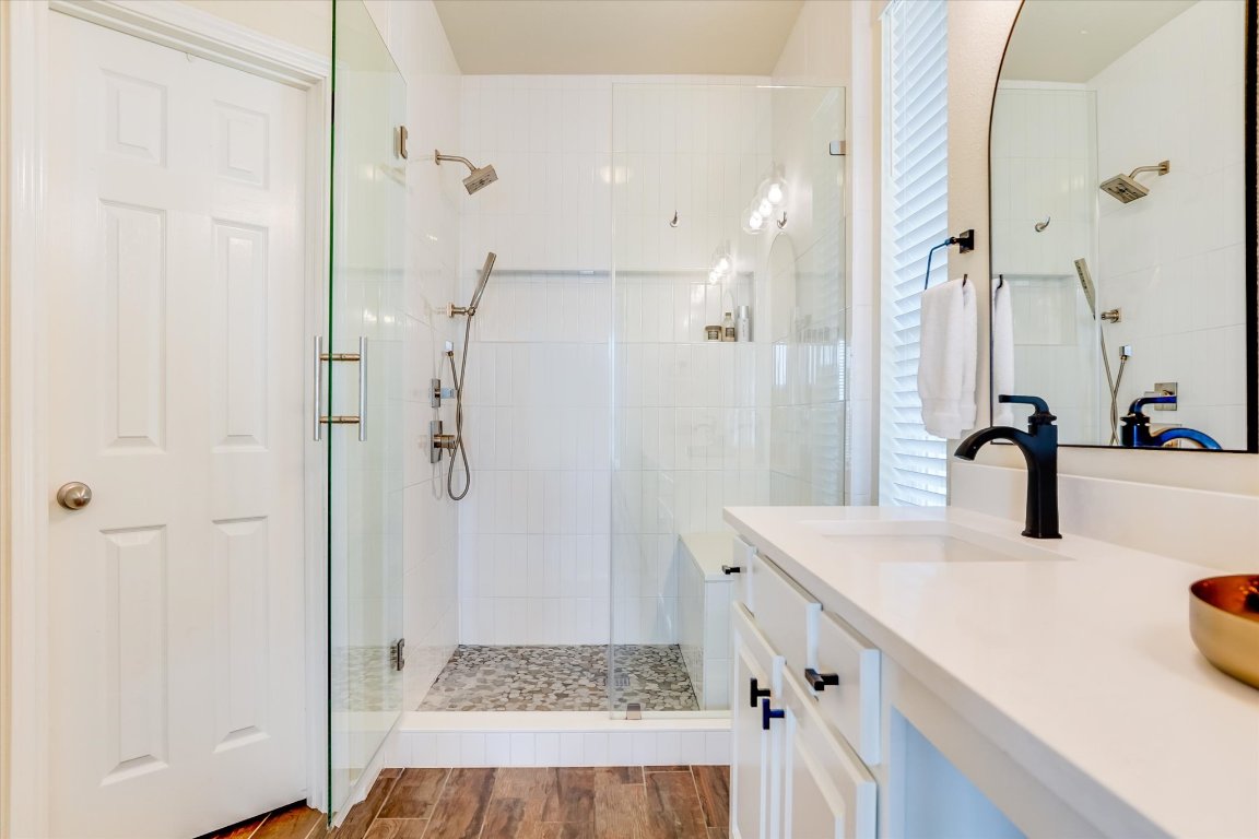 13201 North Ridge Circle Leander, TX 78641 - Photo 20 of 33 a bathroom with a sink a shower and a mirror