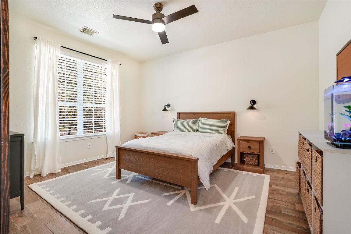 13201 North Ridge Circle Leander, TX 78641 - Photo 21 of 33 a bedroom with a bed and wooden floor
