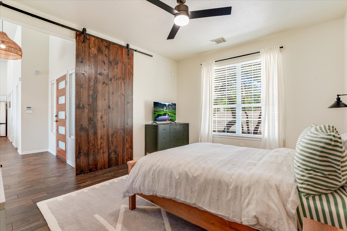 13201 North Ridge Circle Leander, TX 78641 - Photo 22 of 33 a bedroom with a bed and wooden floor