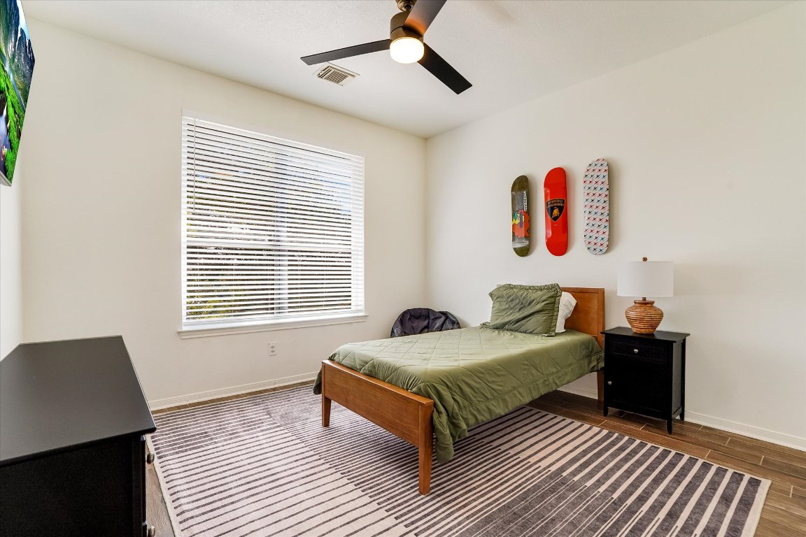 13201 North Ridge Circle Leander, TX 78641 - Photo 24 of 33 a bedroom with a bed and wooden floor