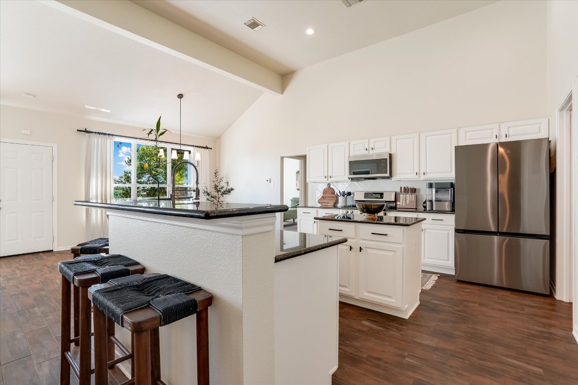 13201 North Ridge Circle Leander, TX 78641 - Photo 10 of 33 a kitchen with stainless steel appliances granite countertop a refrigerator stove microwave and sink