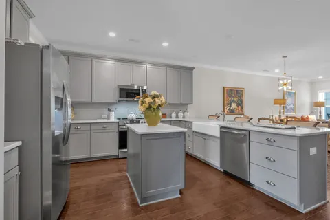 a kitchen with a sink refrigerator and cabinets