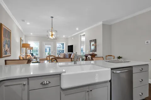 a kitchen with sink stove and cabinets