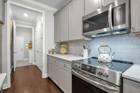 a kitchen with stainless steel appliances granite countertop a stove and a microwave