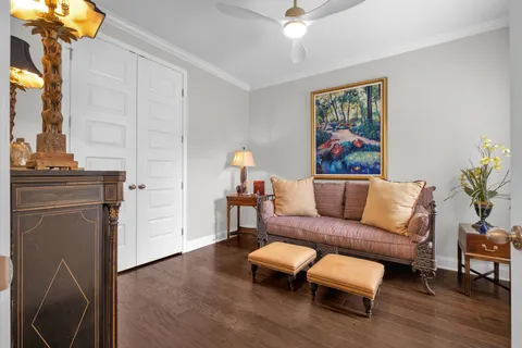 a living room with furniture and a painting on the wall