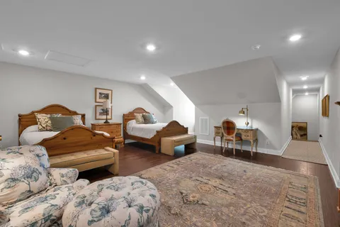 a bedroom with furniture and a chair