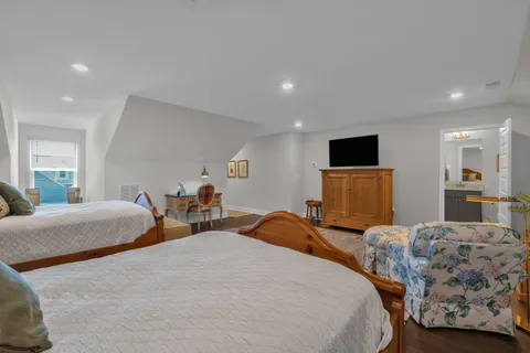 a bedroom with two beds and a television