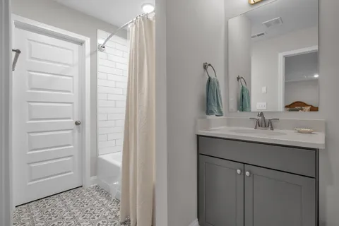 a bathroom with a granite countertop sink and a mirror