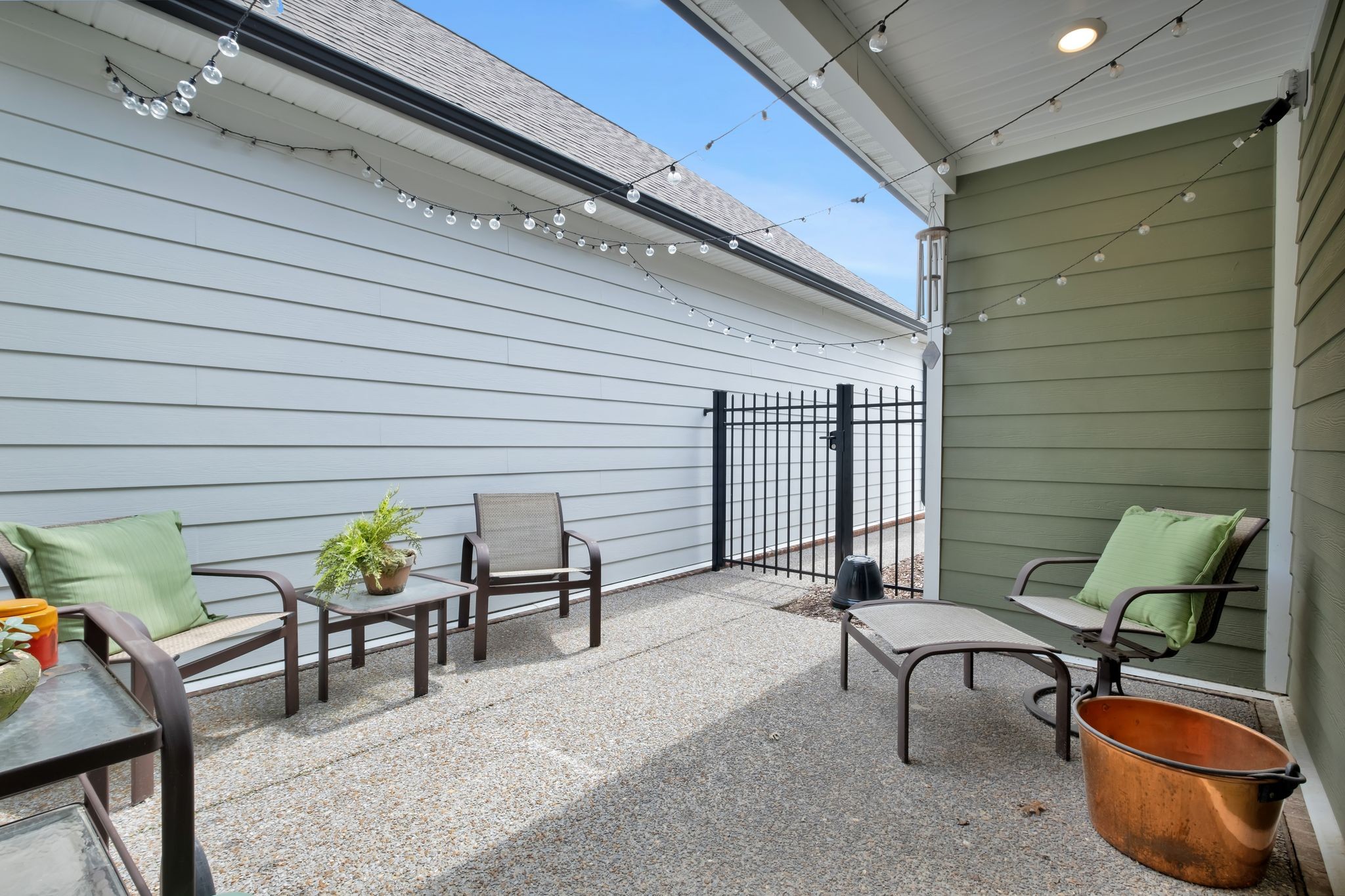 131 Calm Waters Street Franklin, TN 37064 - Photo 29 of 32 a view of a patio with table and chairs and potted plants