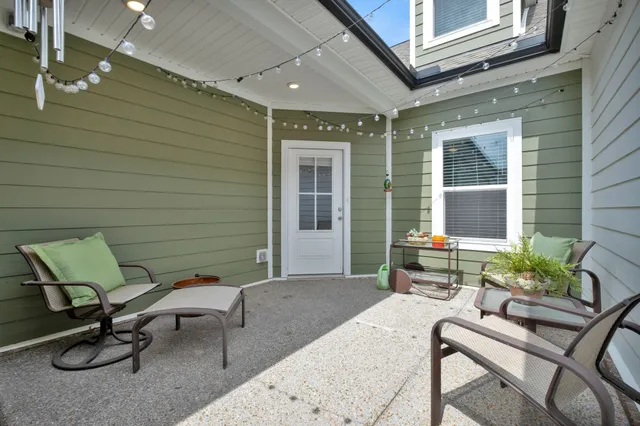 a building outdoor space with patio furniture and potted plants