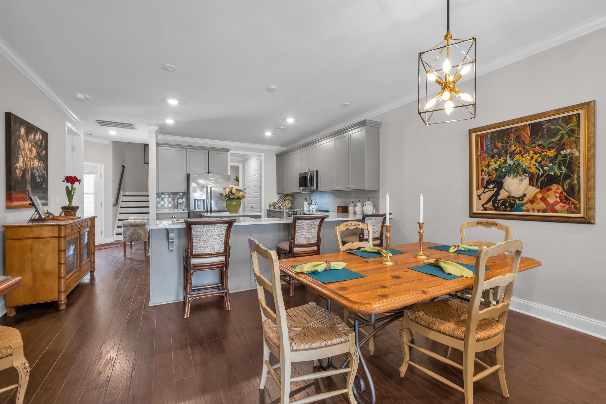 131 Calm Waters Street Franklin, TN 37064 - Photo 8 of 32 a dining room with wooden floor a chandelier a glass table and chairs