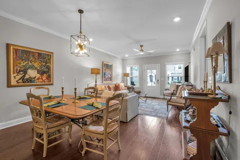 a view of a dining room with furniture a chandelier and wooden floor