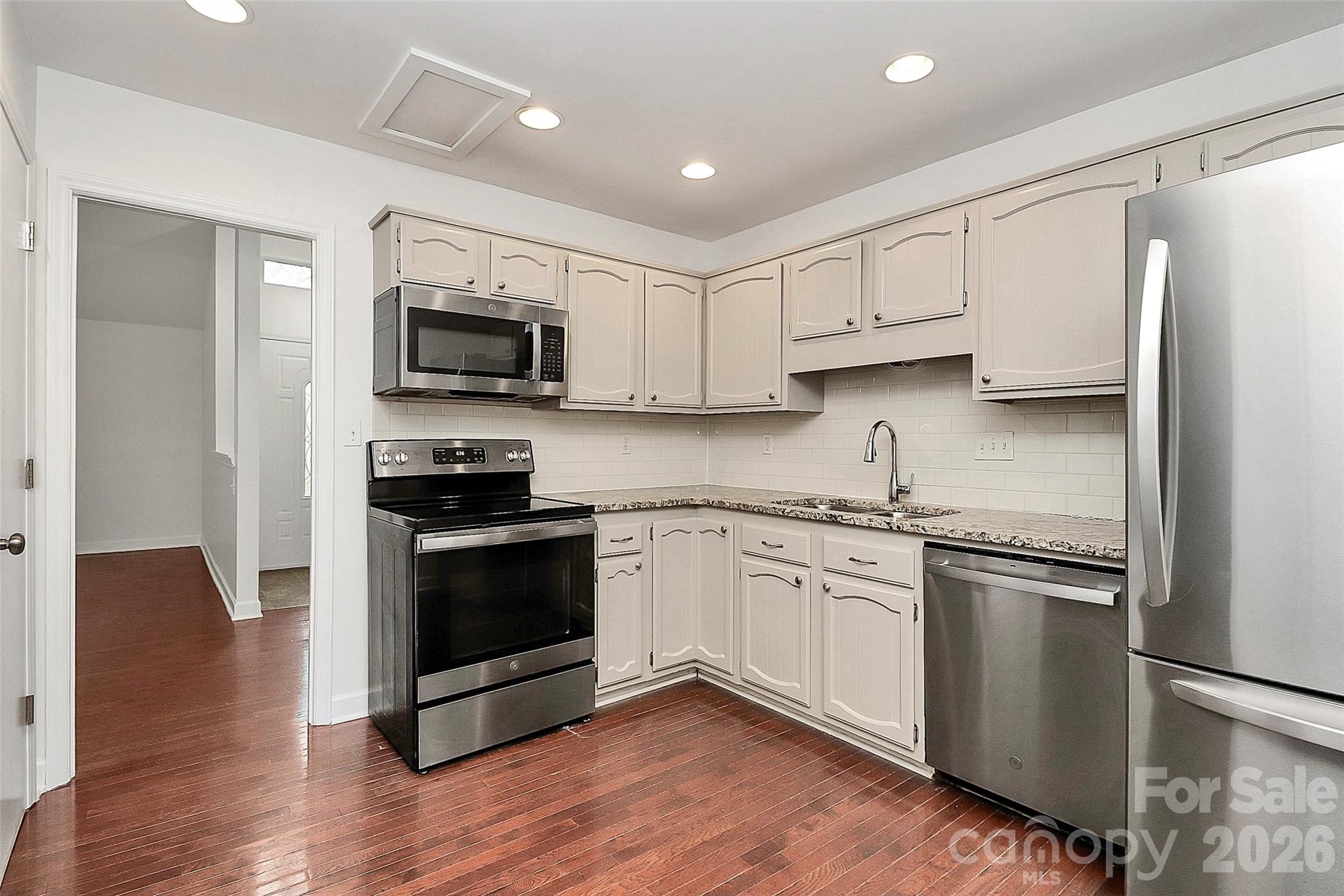 9421 Fairway Ridge Road Charlotte, NC 28277 - Photo 12 of 36 a kitchen with stainless steel appliances granite countertop a stove top oven a sink and a refrigerator
