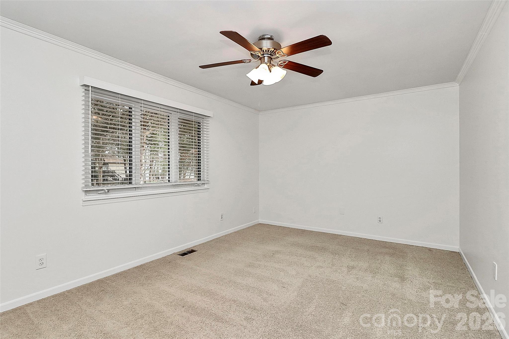 9421 Fairway Ridge Road Charlotte, NC 28277 - Photo 16 of 36 an empty room with ceiling fan and windows