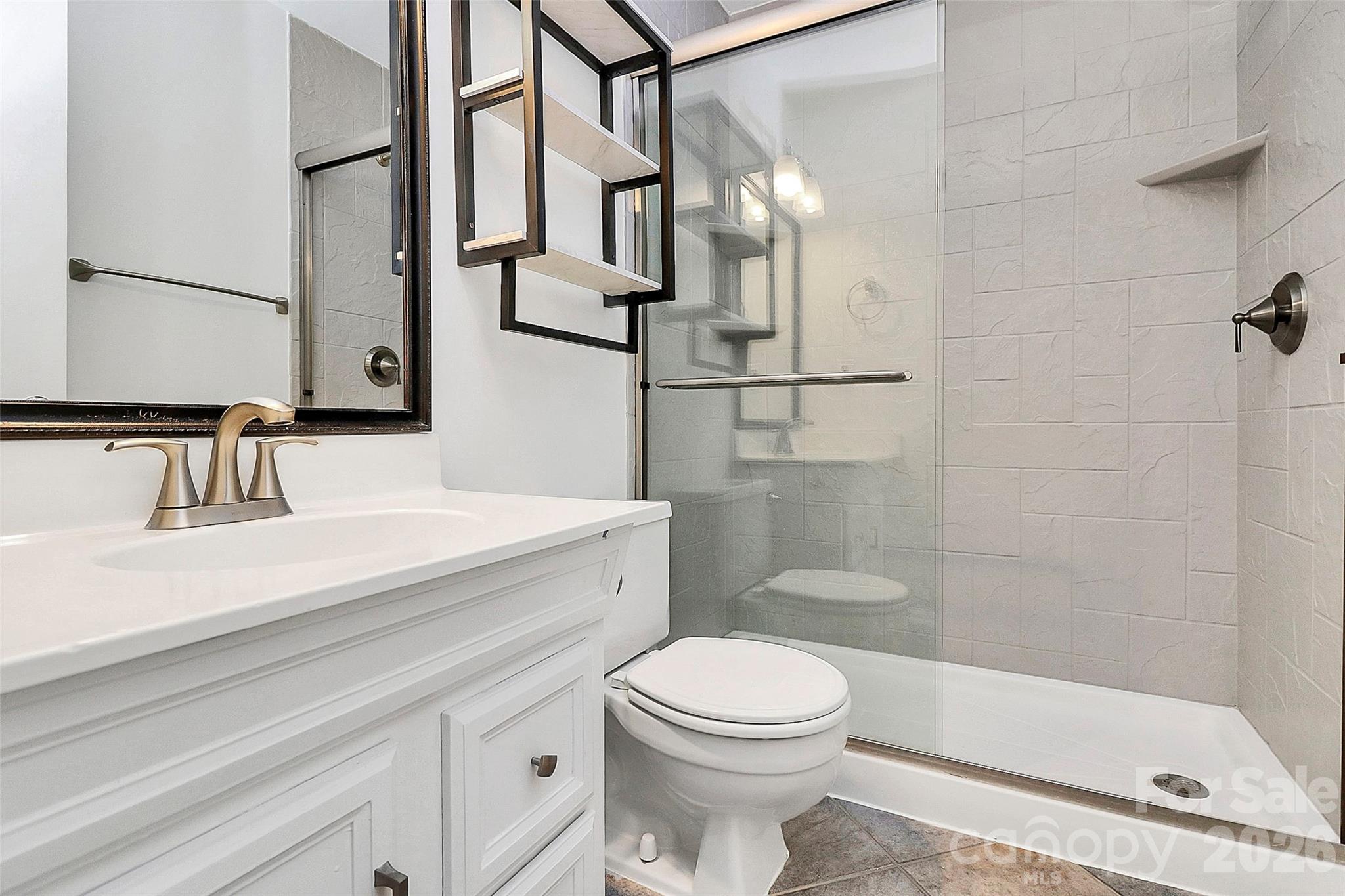 9421 Fairway Ridge Road Charlotte, NC 28277 - Photo 19 of 36 a bathroom with a sink a toilet and shower
