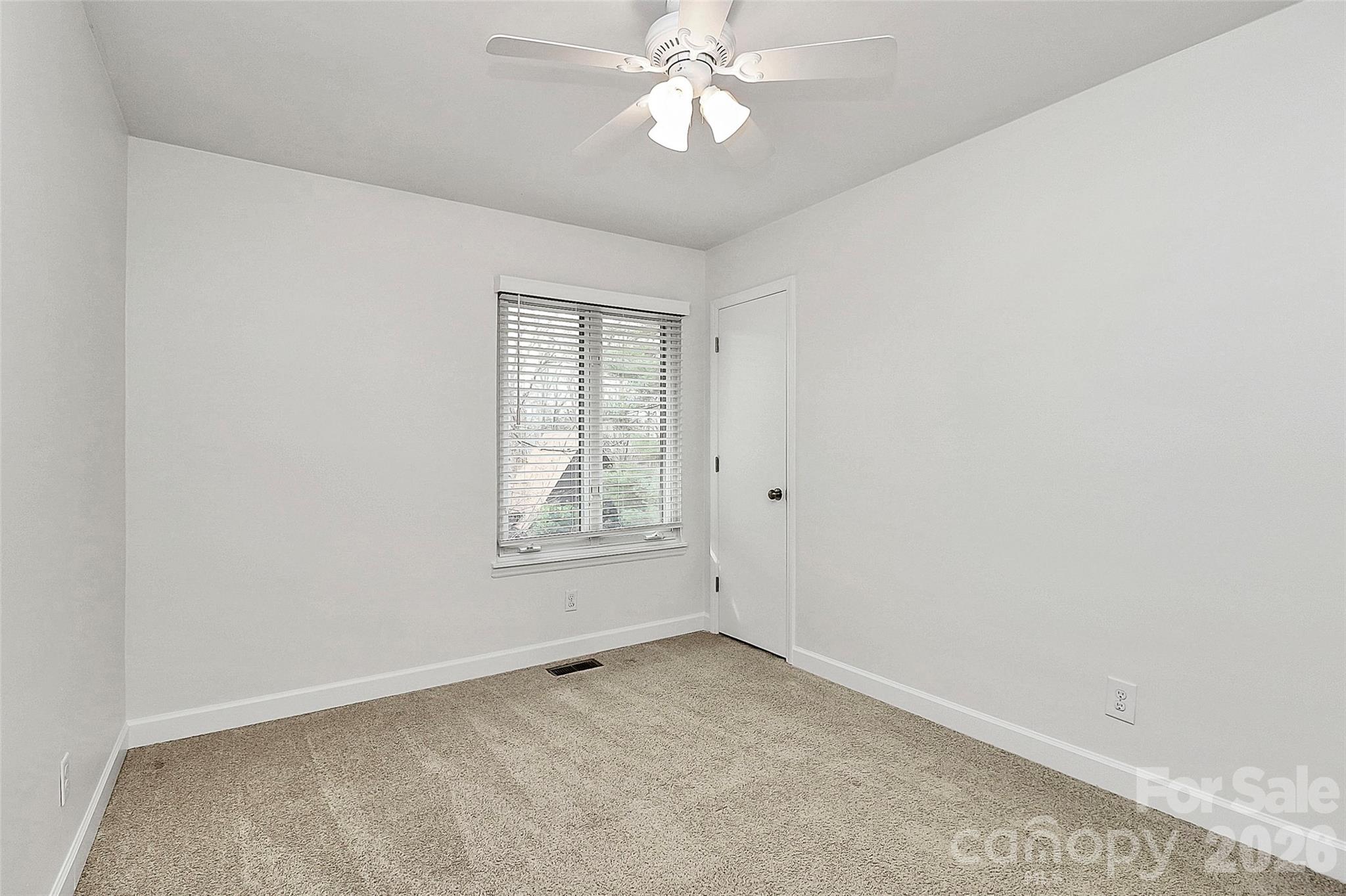 9421 Fairway Ridge Road Charlotte, NC 28277 - Photo 22 of 36 an empty room with windows and fan