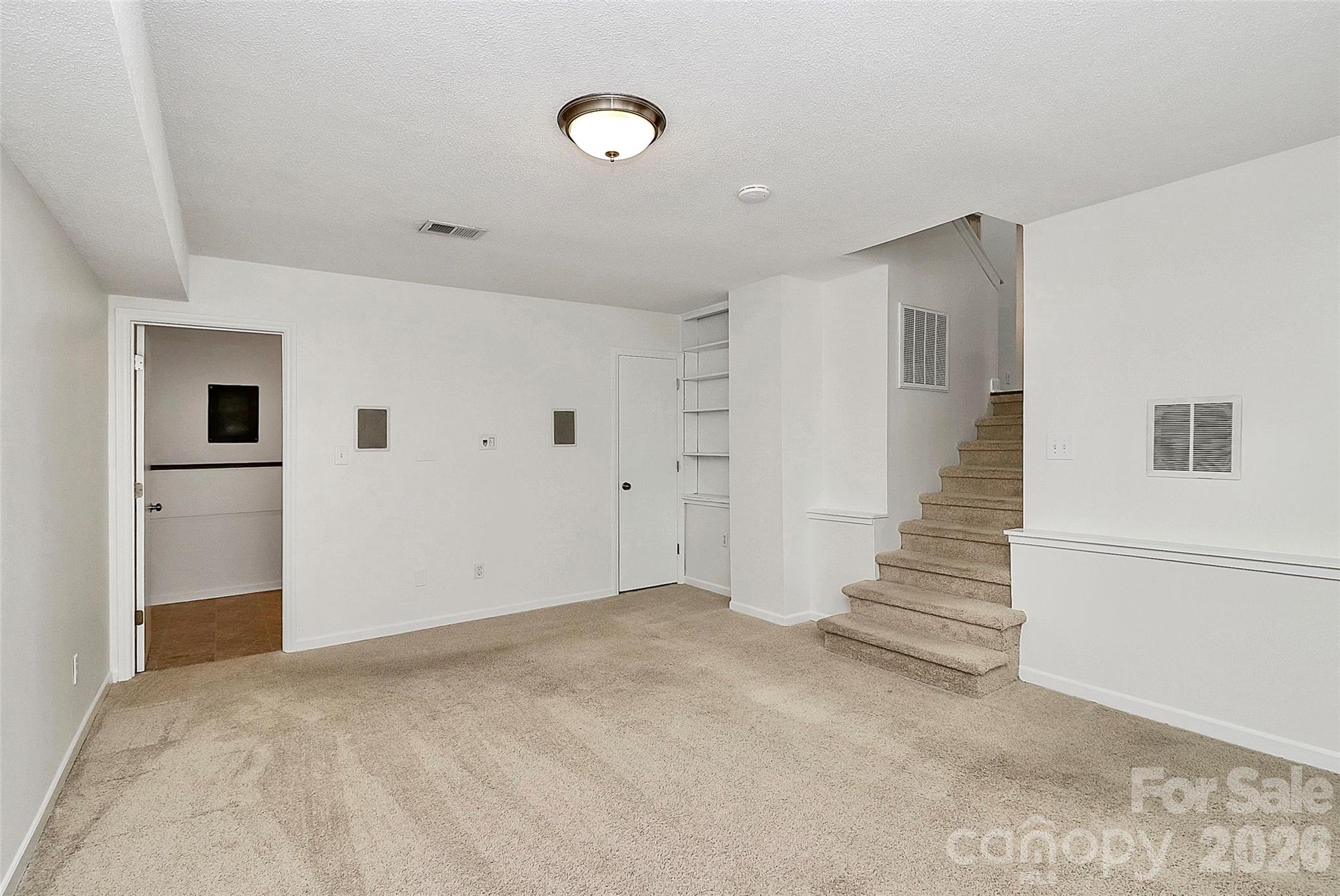 9421 Fairway Ridge Road Charlotte, NC 28277 - Photo 26 of 36 a view of an empty room with stairs and a bathroom