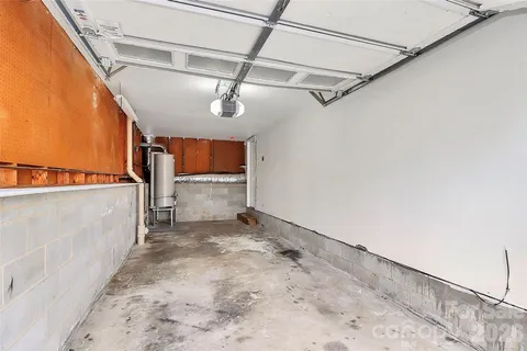 a view of a deck with large trees and wooden fence