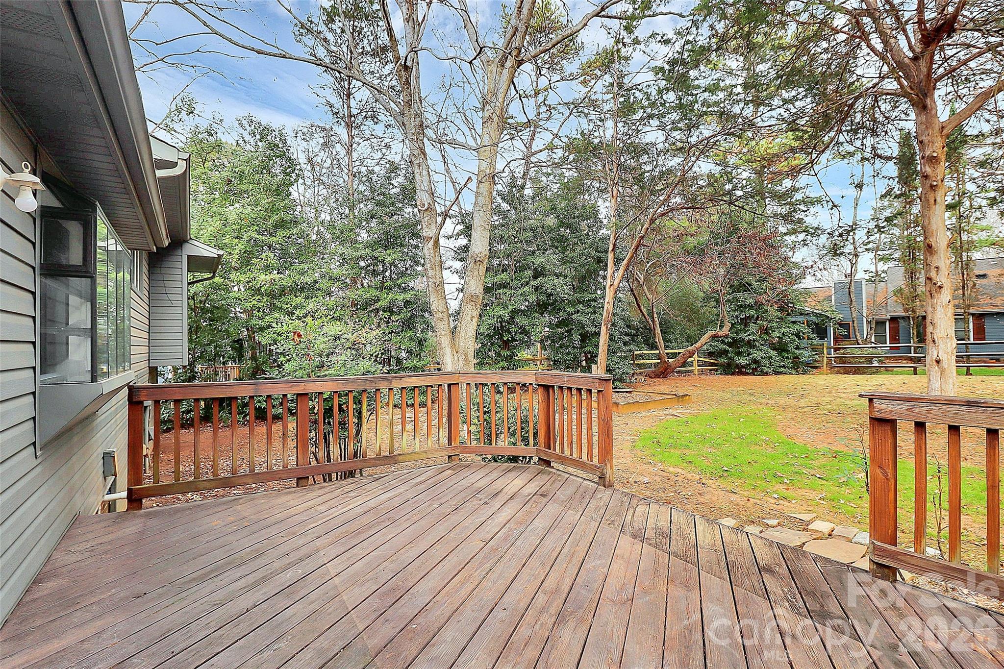 9421 Fairway Ridge Road Charlotte, NC 28277 - Photo 29 of 36 a view of a deck with large trees and wooden fence