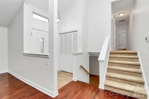 a view of a hallway with wooden floor and entryway