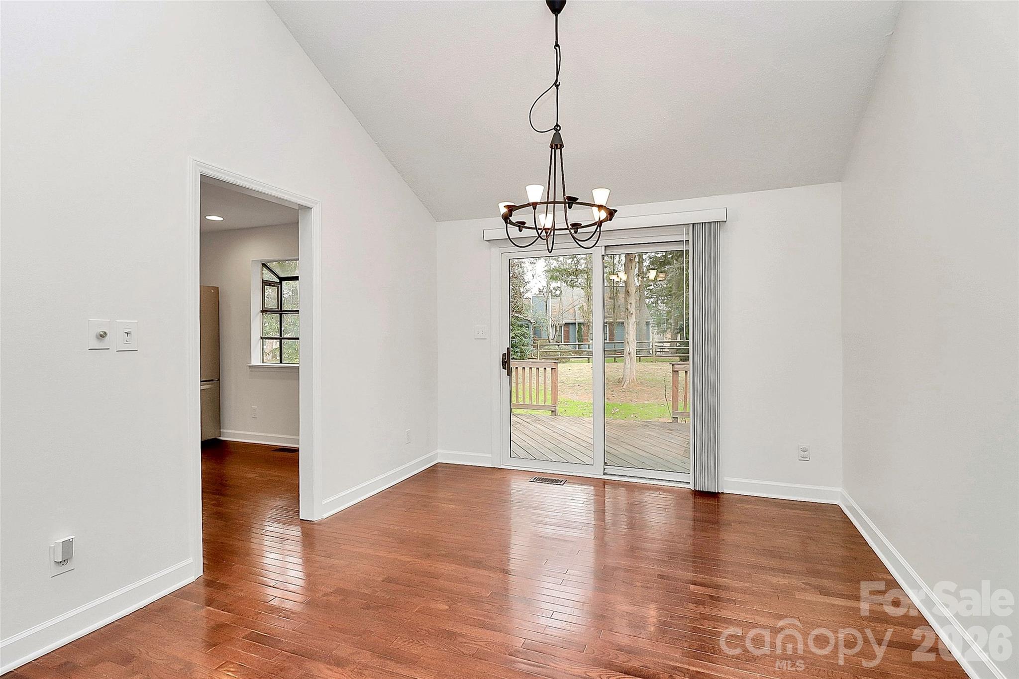 9421 Fairway Ridge Road Charlotte, NC 28277 - Photo 9 of 36 a view of an empty room with window and wooden floor