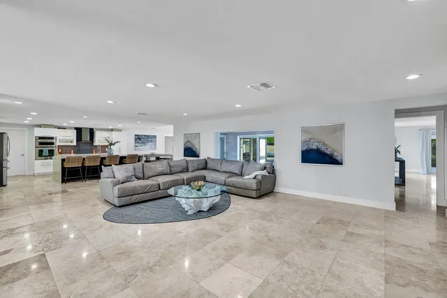 a living room with furniture and kitchen view