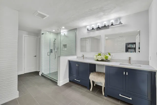 a spacious bathroom with a double vanity sink and a mirror