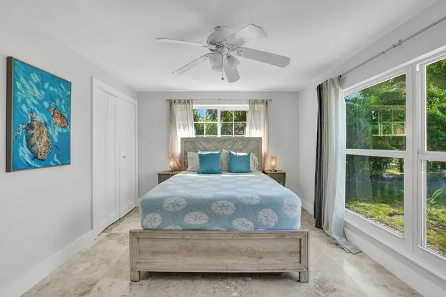 a bedroom with a bed and a painting on the wall