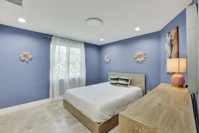 a bedroom with double bed and a window