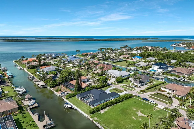 an aerial view of a house with a lake view