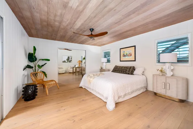 a spacious bedroom with a bed and a chandelier
