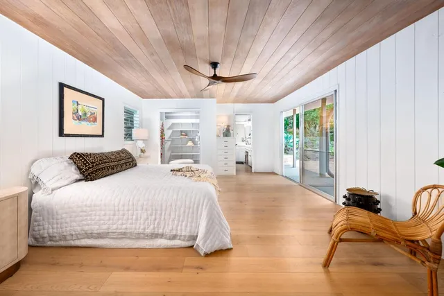 a bedroom with a bed and glass windows