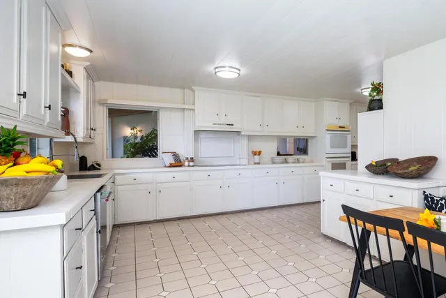 a kitchen with a stove a sink and a refrigerator