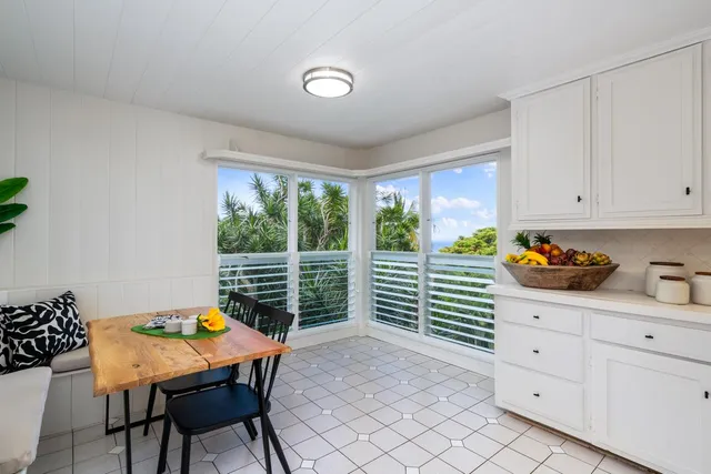 a dining room with furniture and window