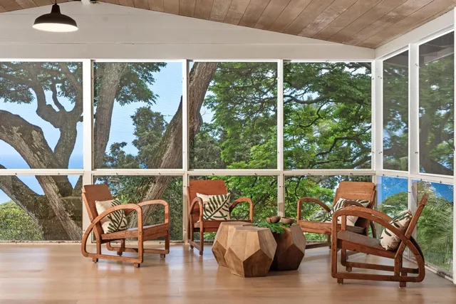 a balcony with chairs and wooden floor