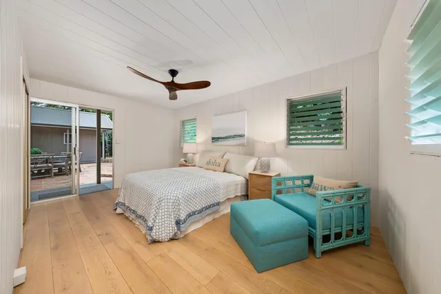 a spacious bedroom with two beds and a chandelier