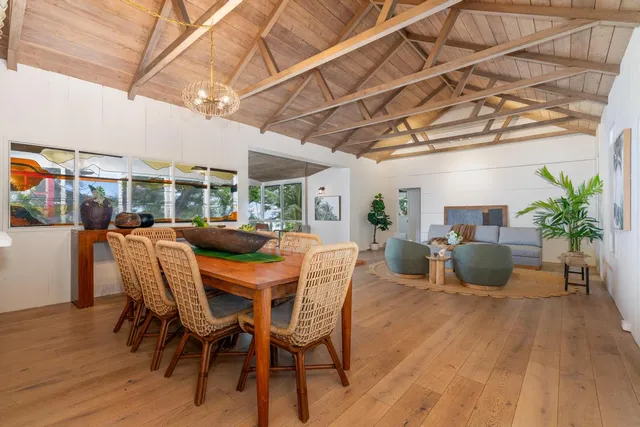 a dining room with furniture and wooden floor