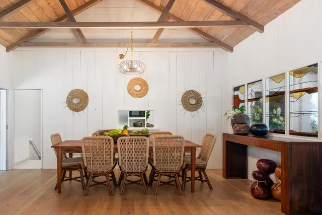 a dining room with furniture and a window
