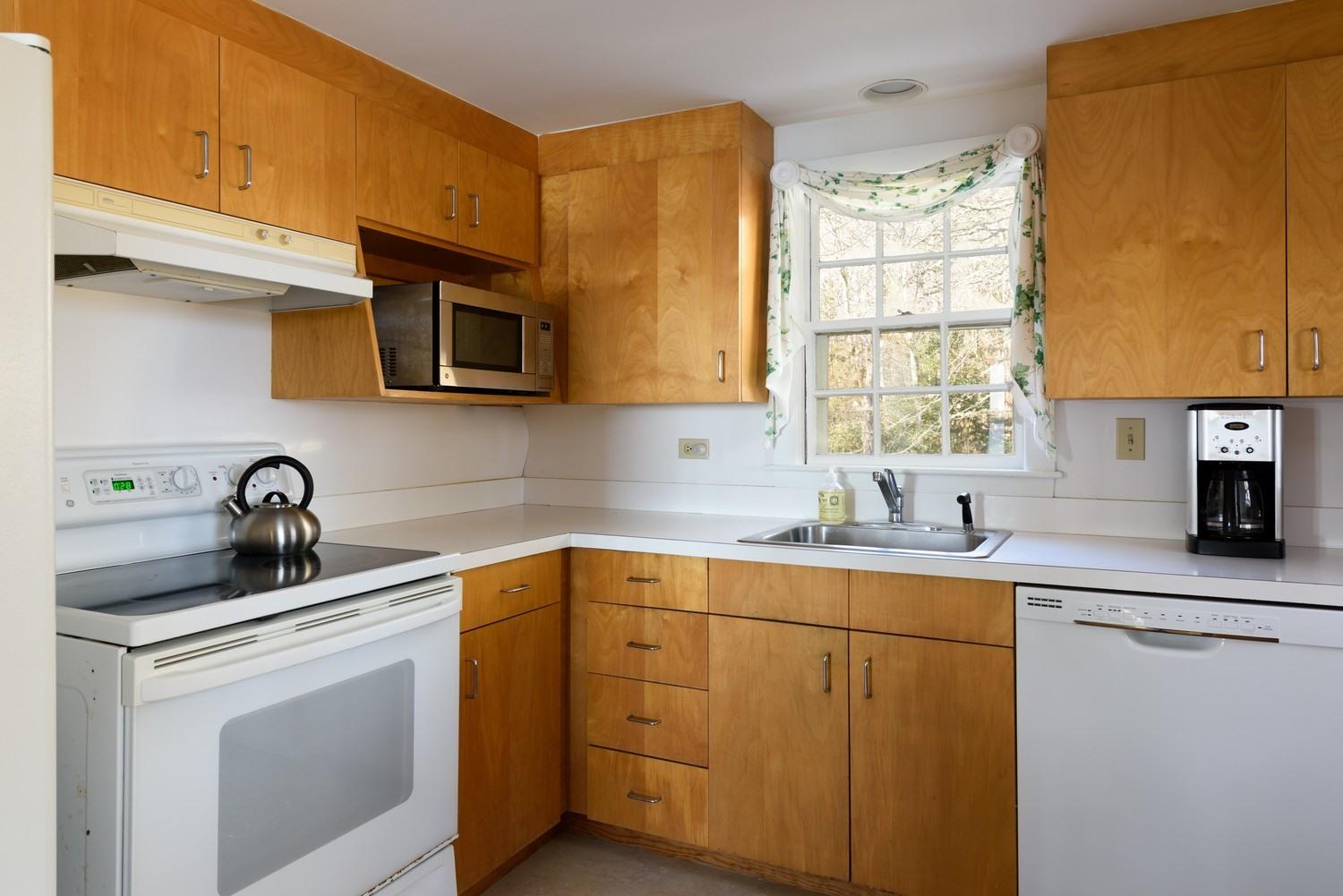16 Lakeview Drive Centerville, MA 02632 - Photo 15 of 34 a kitchen with a sink stove and cabinets